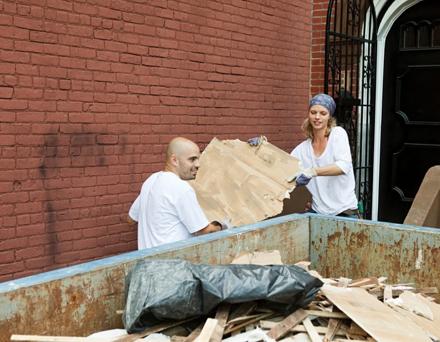 Two people working together on a community cleanup project